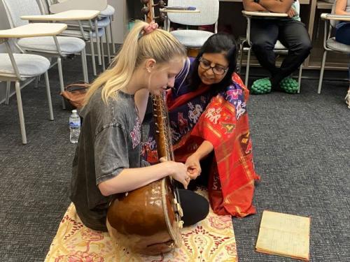 Nirdosh Shaunak assisting student with sitar