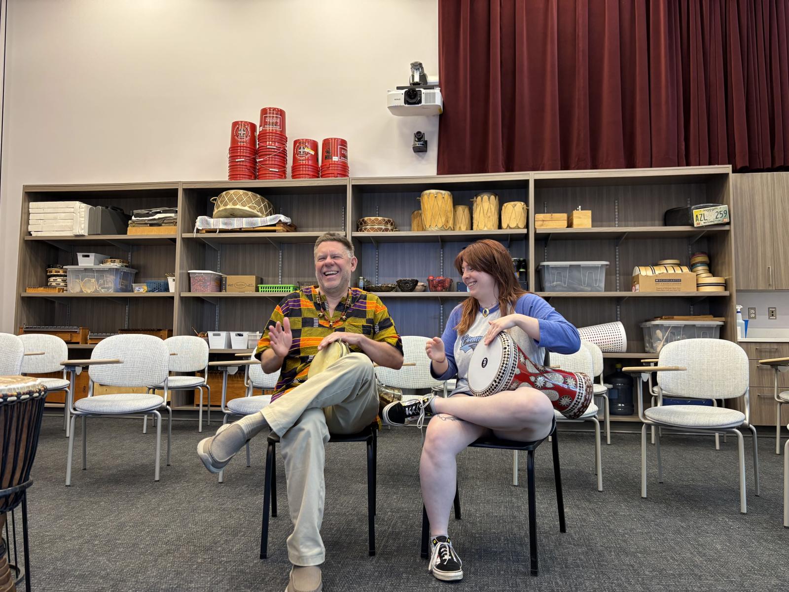 Student and teacher playing drums